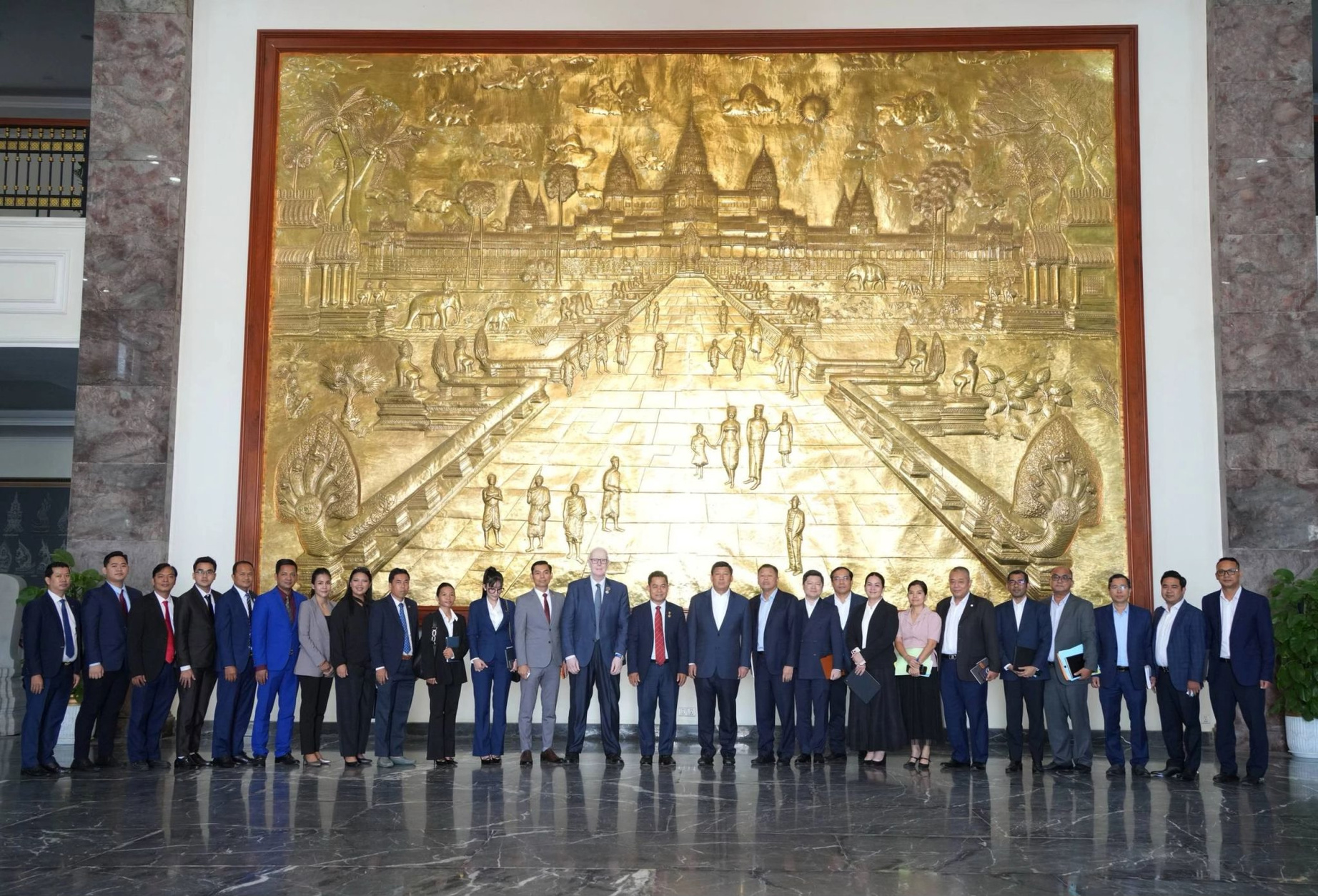 International delegation beneath the golden Cambodia mural